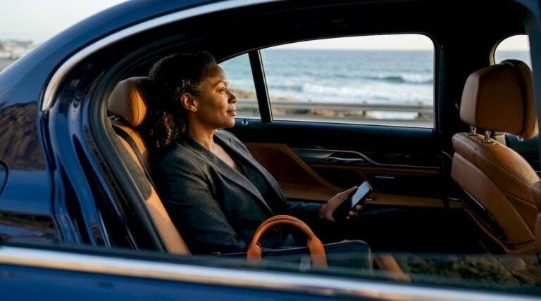 Businesswoman in luxury car on highway