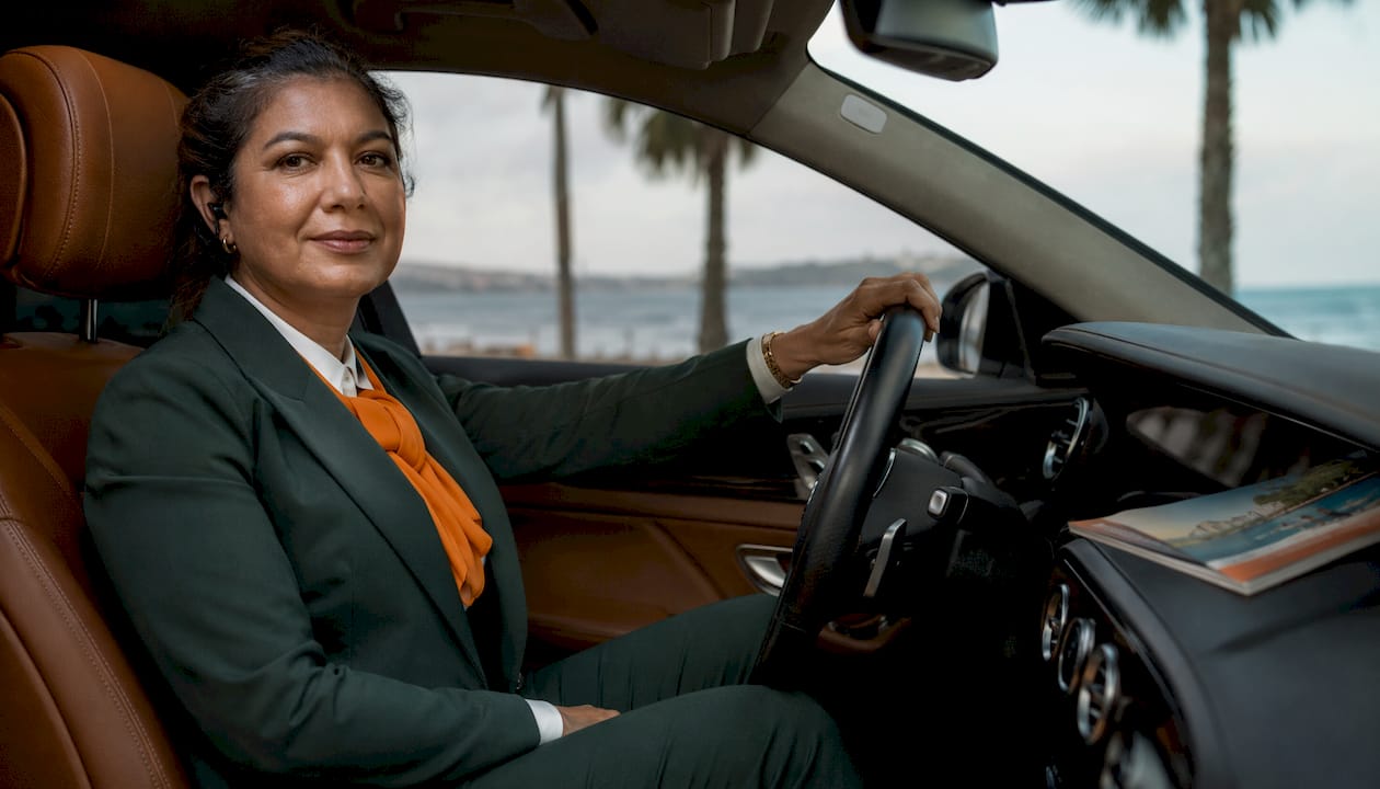 Female professional English-speaking driver in car