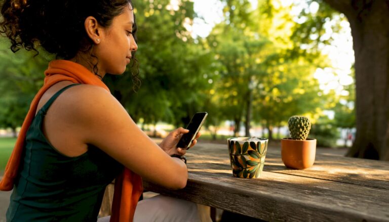 Woman using WhatsApp for transport quote outdoors